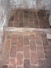Brick flooring under the PTO shaft.