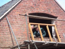 Installing a hardwood window frame.